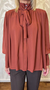 Blusa con trappeggio