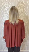Blusa con trappeggio
