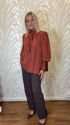 Blusa con trappeggio
